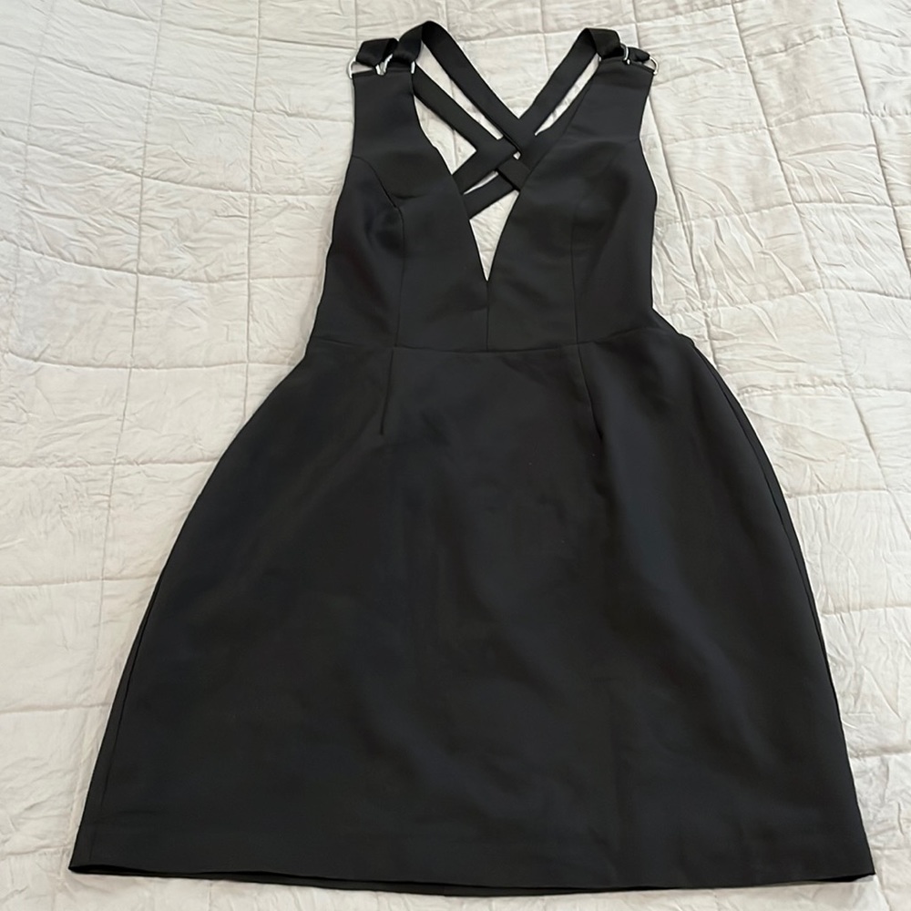NBD black cocktail dress. Backless with only straps. Silver tone accent. Small